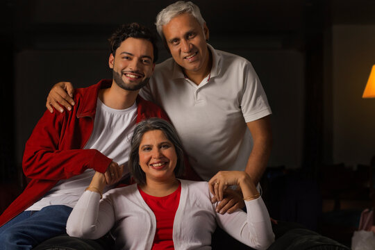 Portrait of senior couple with his son at home
