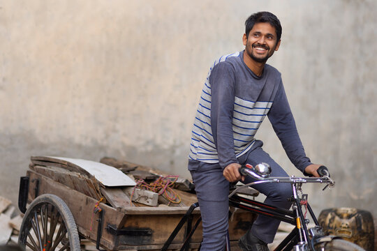 A Rickshaw puller taking away scrap