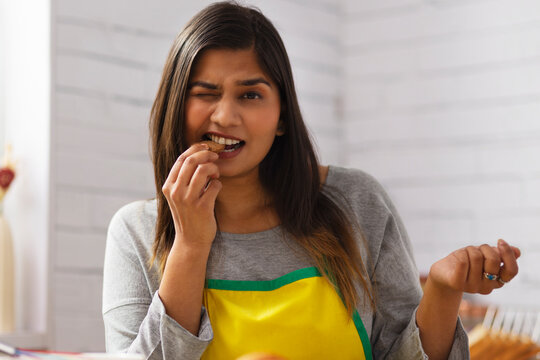 Close-up portrait of woman eating cookies