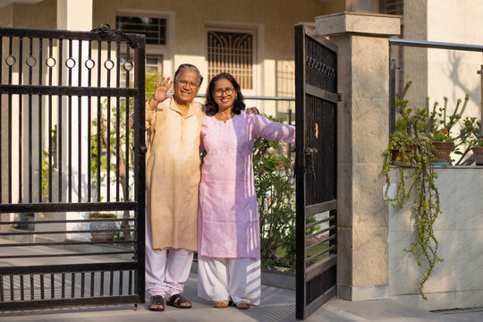 Happy Mature couple standing together at gate 