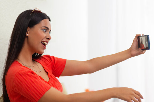 Portrait of young woman with sunglasses taking selfie 