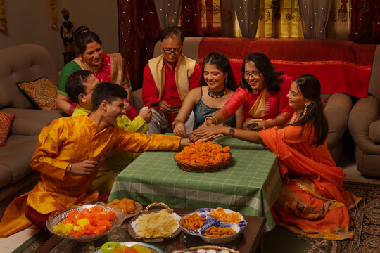 Happy family in traditional outfit celebrating Diwali together at home