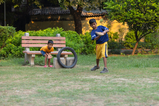 Portrait of boy hitting a shot while playing cricket in the park