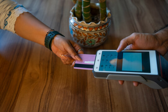 A buyer making a payment through a card machine 