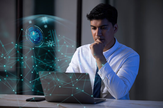 Businessman working on laptop computer with icons on virtual screen
