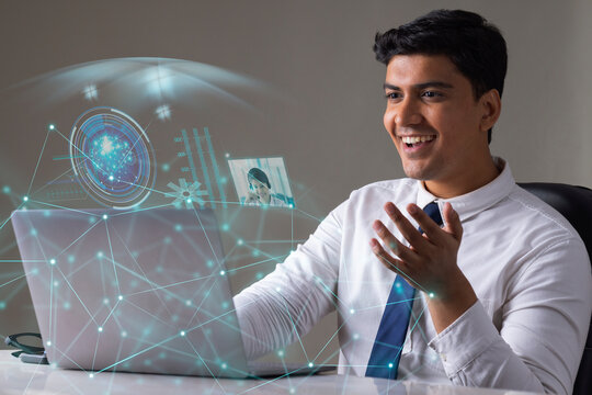 Businessman working on laptop computer with icons on virtual screen