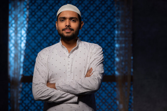 Portrait of a Muslim man looking at camera with folded hands