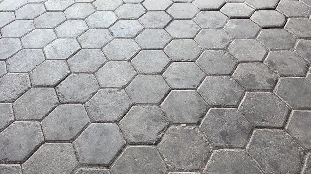 Hexagonal concrete paving blocks pattern on outdoor driveway texture