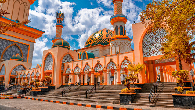 Exterior view Masjid Raya Hubbul Wathan largest mosque Lombok modern Islamic architecture colorful towers city skyline backdrop