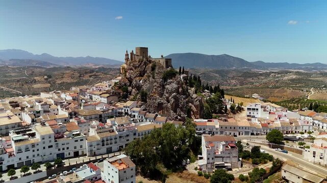 Aerial drone approach to Olvera Castle on rocky mountain peak, Cadiz, Spain