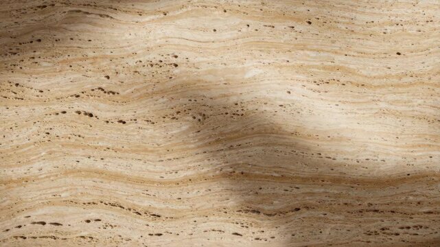 Dynamic Shadows Moving Across a Textured Beige Travertine Stone Surface.