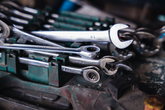 Organized set of metric combination wrenches and spanners in a mechanic toolbox. Professional automotive hand tools for auto repair, garage maintenance, and vehicle fixing services