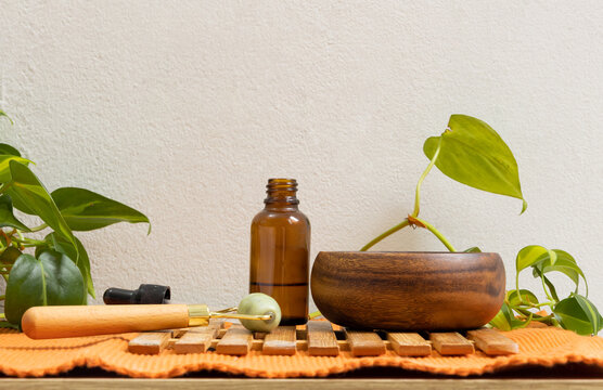 Facial serum, facial massager, and skincare products on a table. Concept of spa, skin care, beauty, self care, wellness, and facial care routine