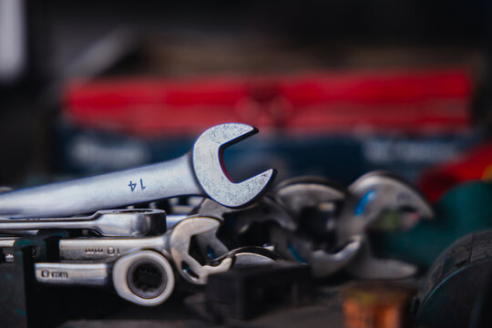 Organized set of metric combination wrenches and spanners in a mechanic toolbox. Professional automotive hand tools for auto repair, garage maintenance, and vehicle fixing services