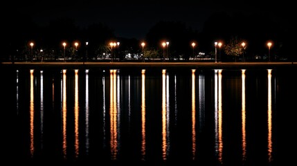 Obraz premium streetlights. Nighttime cityscape with glowing streetlights reflecting on calm water, creating a peaceful urban atmosphere. real-estate listings.
