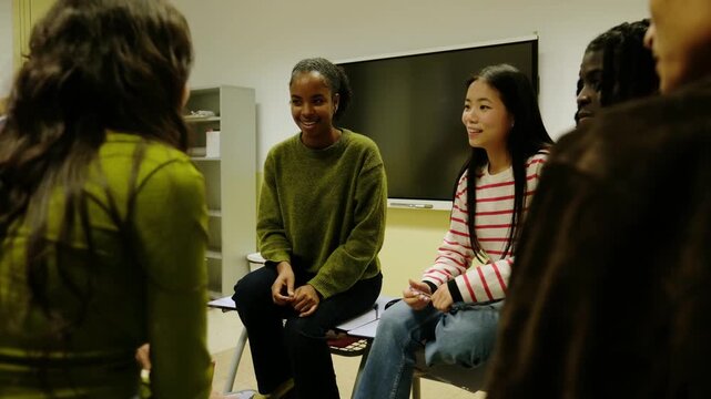 Group of multiethnic high school students discussing and sharing ideas during a support meeting