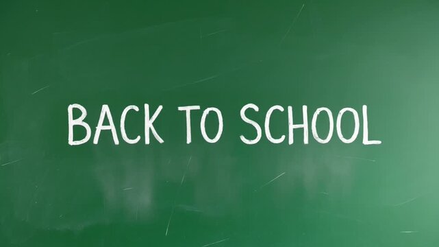 Back to school message on a green chalkboard zooming in slowly