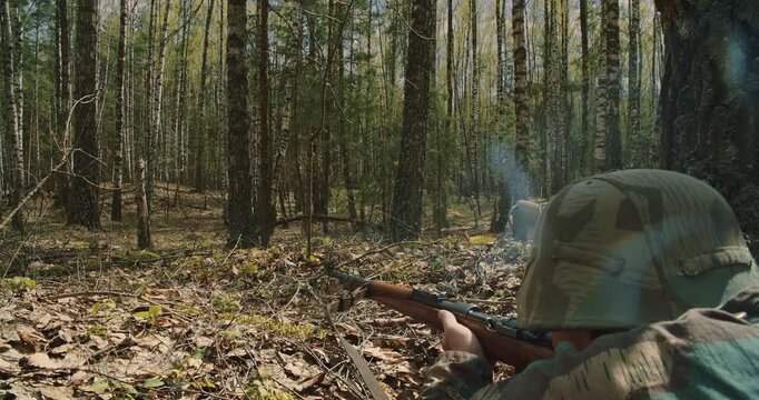 German soldier firing Mauser rifle with smoke in forest battle Side view of Wehrmacht infantryman shooting a bolt-action rifle with visible smoke discharge.