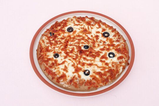 Freshly Baked Mozzarella Cheese Pizza with Black Olives on White Plate, Top View