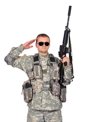 Fototapeta premium Soldier saluting while holding a rifle.