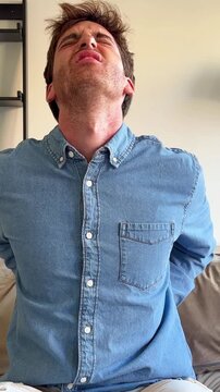 A young man experiences discomfort, possibly back or neck pain, and stretches to relieve the tension. His expressions show initial strain, followed by a sense of release and relaxation, highlighting s