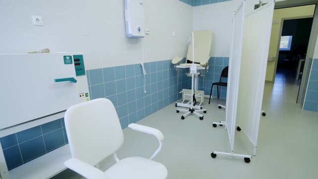 Gynecology office contains adjustable gynecological chair. Examination room includes advanced diagnostic technology and clinical supplies