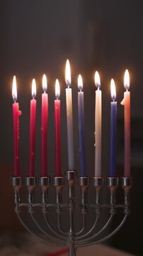 vertical video. People celebrate Hanukkah by lighting candles on the candle. Jewish festive joy kindles Hanukkah, menora - candles on the sacred Hanukkah. Candles on the Hanukkah. 