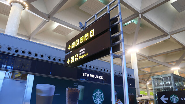 Airport arrivals sign and Starbucks cafe inside Tenerife South Airport, Spain, 16.6.2026