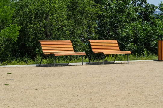 Two wooden benches in the park. The concept of leisure and recreation.