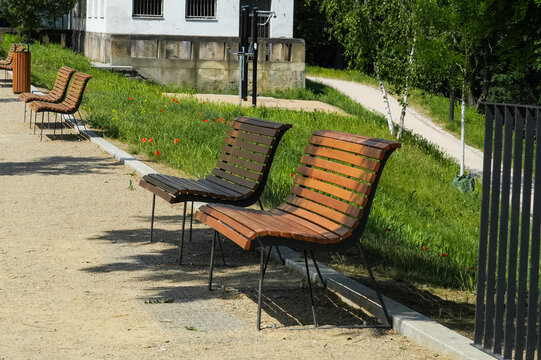 Two wooden benches in a park on a sunny summer day, Czech Republic