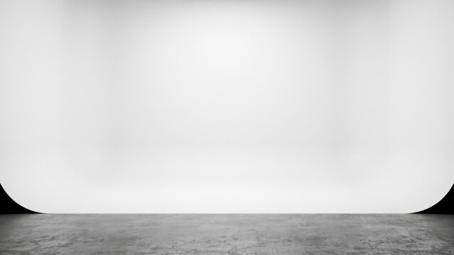 Empty photo studio with white cyclorama wall and concrete floor