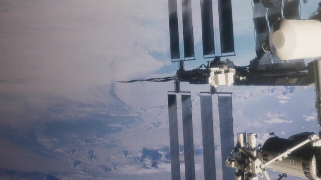 A space station is seen floating in low Earth orbit. Solar panels are deployed on the station. The blue planet is visible below. This scene captures the connection between Earth and space.