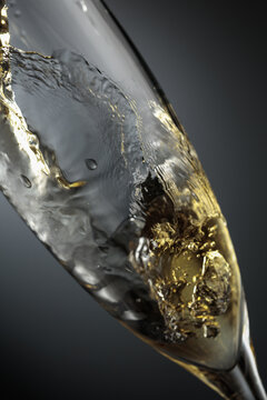 White sparkling wine is poured into a glass.