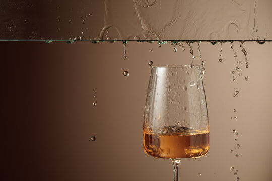 White wine flows down into a glass.