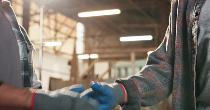 Men, handshake and carpenter team in factory with support, gloves or unity for project development. Partnership, people and shaking hands in timber workshop for collaboration, achievement or feedback