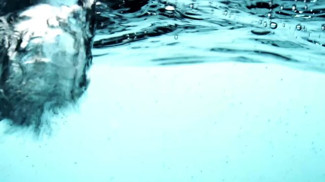 Blue scene of water splashing from lef to right creating little bubbles