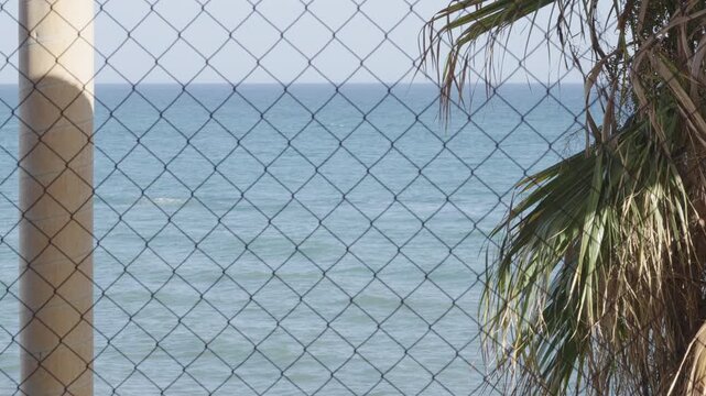 Sea View From Construction Site With Pillar, Wire Fence, Palm tree.  [180&deg; shutter angle n&deg; 1/3 Series 70mm Sony G] from ProRes 442 - 4K60p 10 bit S-Log3, All intra XAVC I