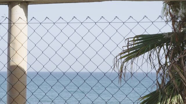 Sea View From Construction Site With Pillar, Wire Fence, Palm tree.  [180&deg; shutter angle n&deg; 1/3 Series 70mm Sony G] from ProRes 442 - 4K60p 10 bit S-Log3, All intra XAVC I