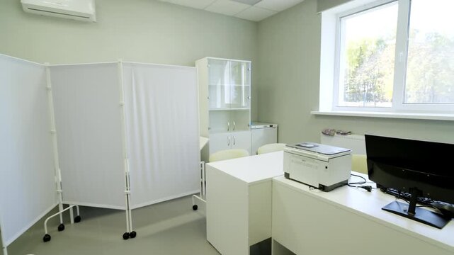 Interior displays tidy hospital office equipped with white wardrobes desk and air conditioner. Quiet structured environment looks ready