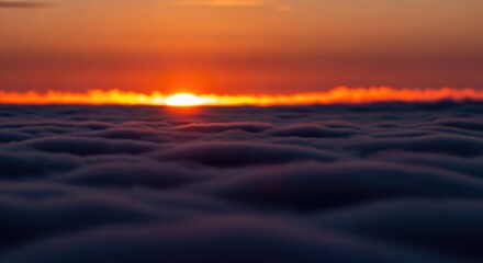 Obraz premium Stunning Sunset Above the Clouds - A Breathtaking Aerial View.