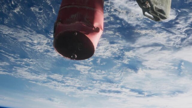 A part of a rocket is visible in low Earth orbit. It shows the moment of stage separation above the clouds. The Earth is seen below with blue skies and some clouds surrounding the spacecraft.