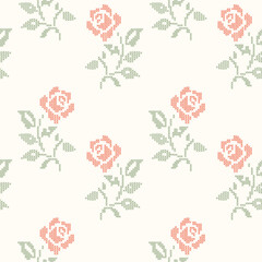 Fototapeta premium Red and green cross-stitch embroidery roses seamless pattern on beige background. A geometric pixelated needlework vintage floral wallpaper for cottagecore crafts, textiles, wrapping, fabric design.