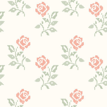 Red and green cross-stitch embroidery roses seamless pattern on beige background. A geometric pixelated needlework vintage floral wallpaper for cottagecore crafts, textiles, wrapping, fabric design.