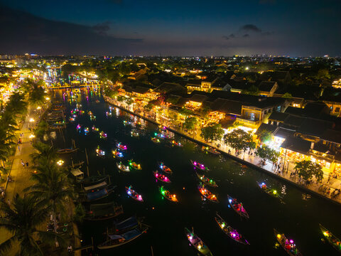 Panorama aerial drone view of Hoi An ancient town with boat tour and beautiful lanterns in night. UNESCO world heritage. One of the most travel popular touristic destinations