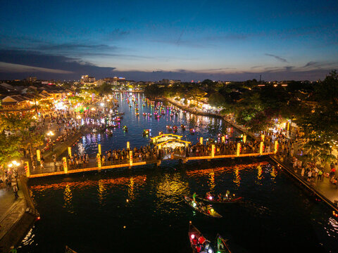 Panorama aerial drone view of Hoi An ancient town with boat tour and beautiful lanterns in sunset. UNESCO world heritage. One of the most travel popular touristic destinations
