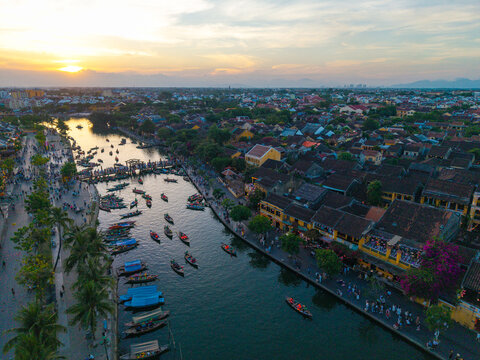 Panorama aerial drone view of Hoi An ancient town with boat tour and beautiful lanterns in sunset. UNESCO world heritage. One of the most travel popular touristic destinations
