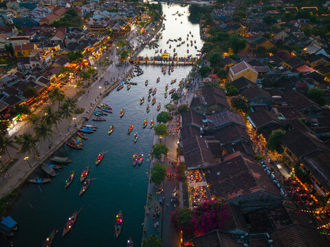 Panorama aerial drone view of Hoi An ancient town with boat tour and beautiful lanterns in sunset. UNESCO world heritage. One of the most travel popular touristic destinations
