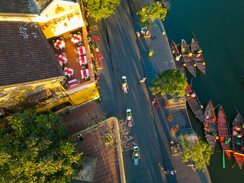 Aerial panoramic view of Hoi An city, Da Nang province, Vietnam. Pedicabs carrying tourists for sightseeing in the old town, UNESCO world heritage. One of the most travel popular touristic destination