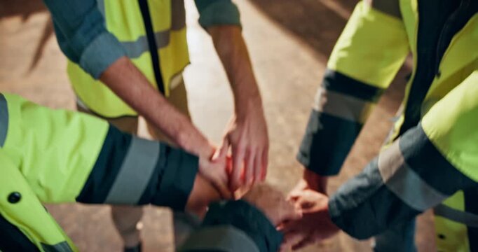 Warehouse, team or mission with hands together in huddle for unity, solidarity or synergy. Group, people or contractors piling with stack, trust or support for distribution, supply chain or inclusion