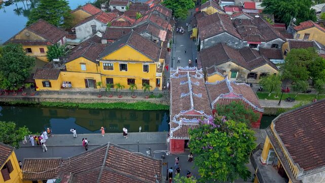 Timelapse or time-lapse of aerial view of Chua Cau or Japanese Covered ancient Bridge and River in Hoi An, Vietnam. Vietnamese heritage and culture in Hoian ancient town
